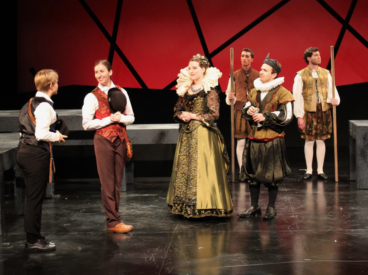 Court Act 1. Rosencrantz and Guildenstern with Claudius and Gertrude with guards in background.